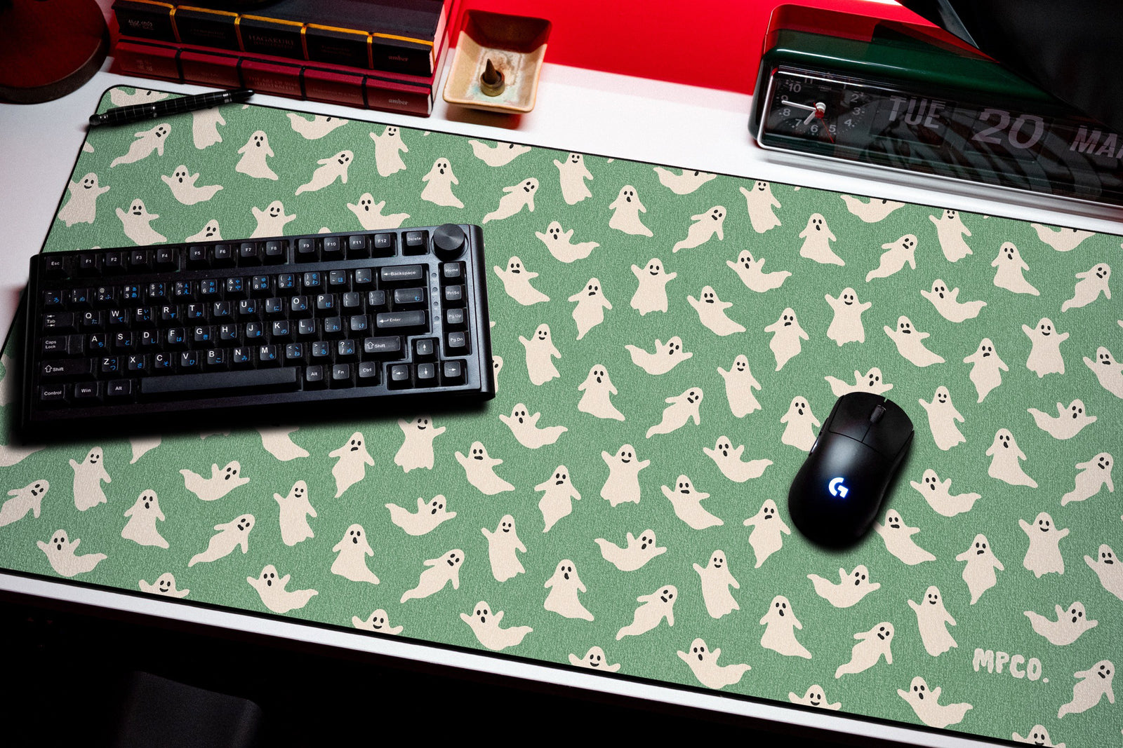 Ghosts desk mat in Green, shown on a styled desk setup