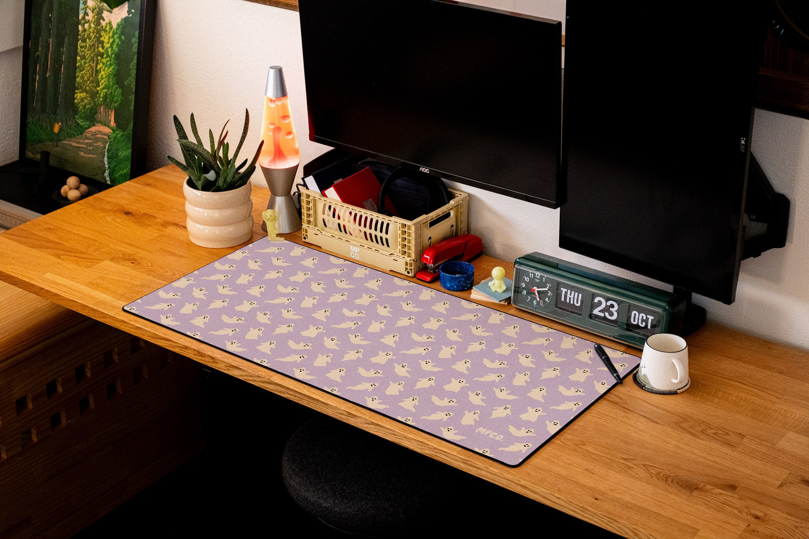 Ghosts desk mat in Purple, shown on a styled desk setup