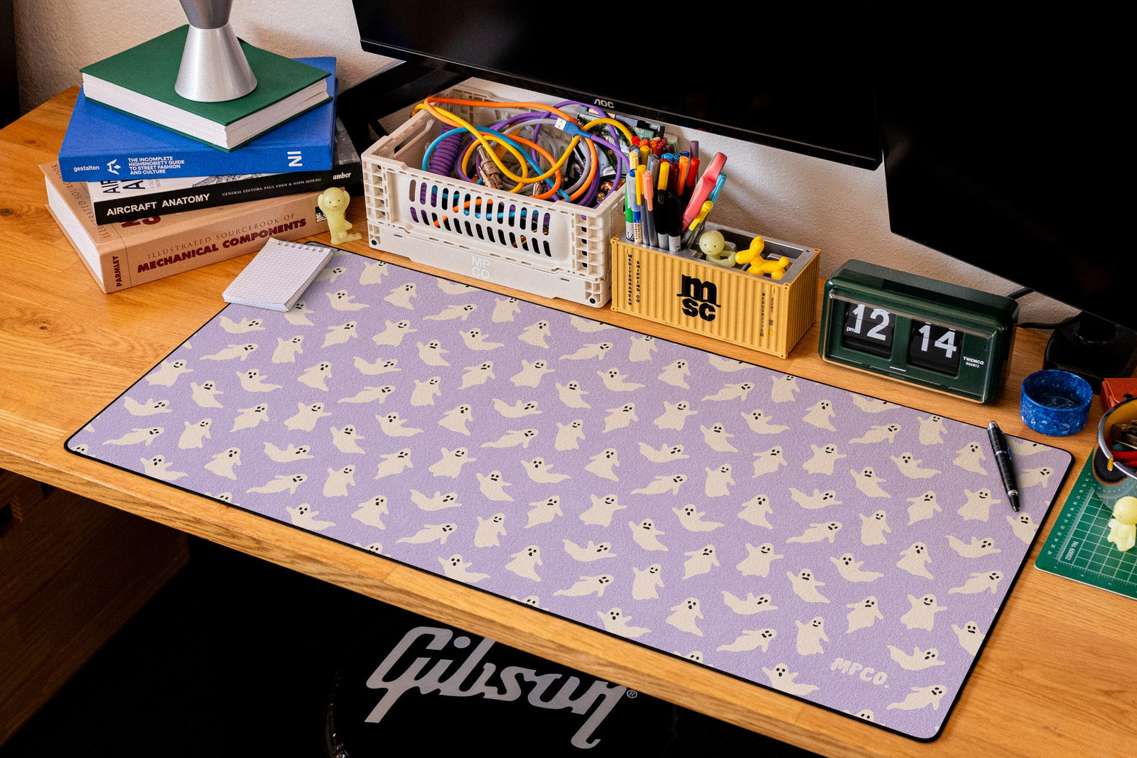 Ghosts desk mat in Purple, shown on a styled desk setup