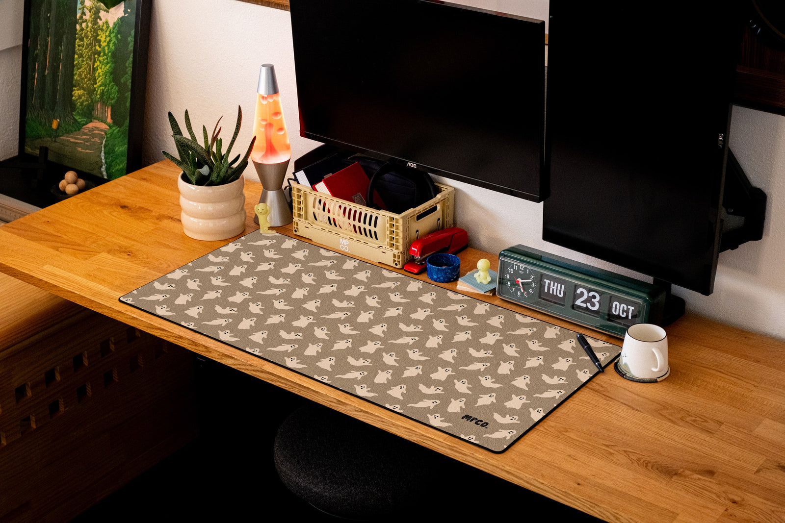 Ghosts desk mat in Sand, shown on a styled desk setup