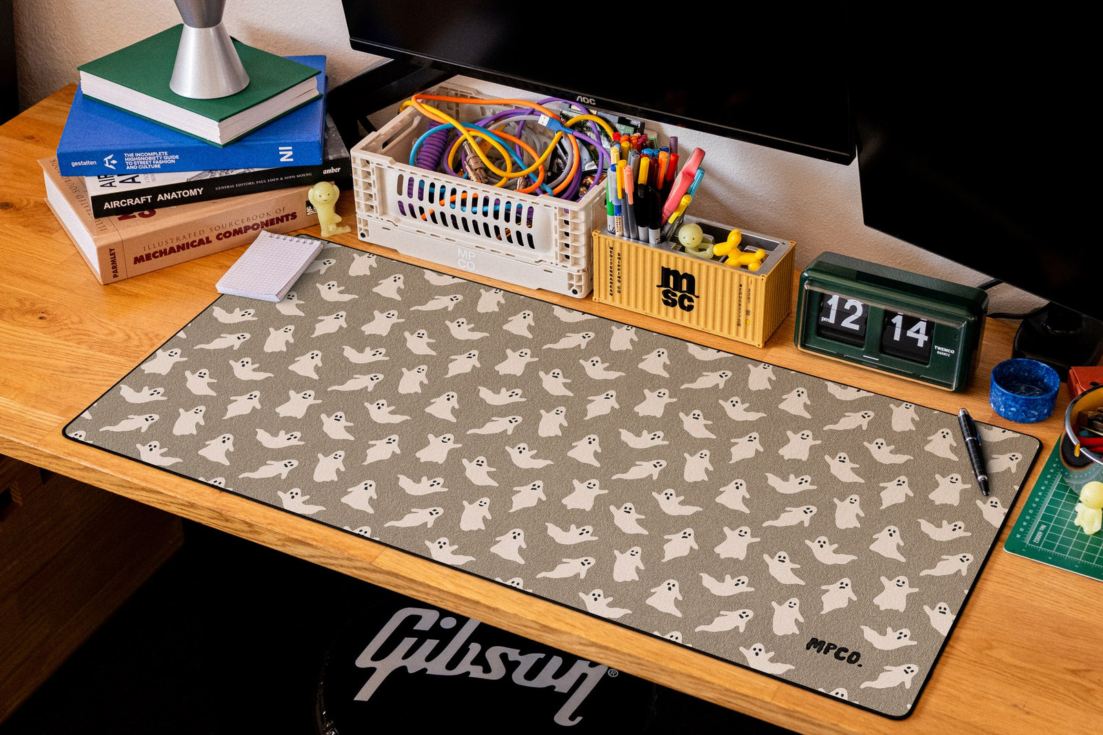 Ghosts desk mat in Sand, shown on a styled desk setup