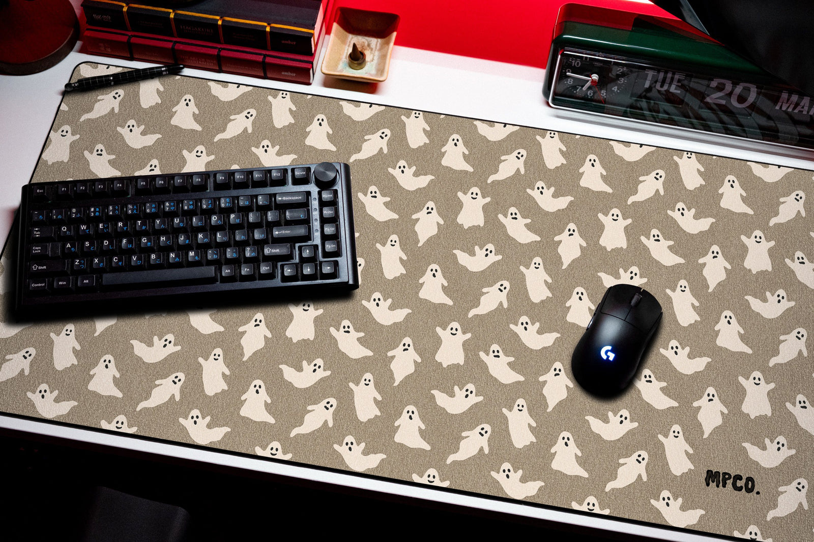 Ghosts desk mat in Sand, shown on a styled desk setup