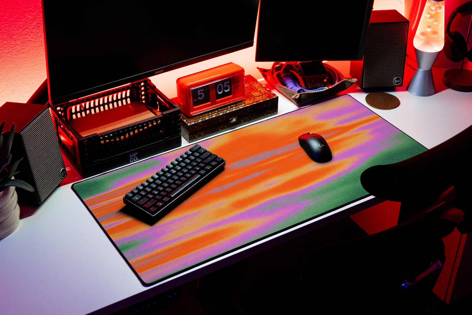 Glare desk mat in Mango Pulse, shown on a styled desk setup