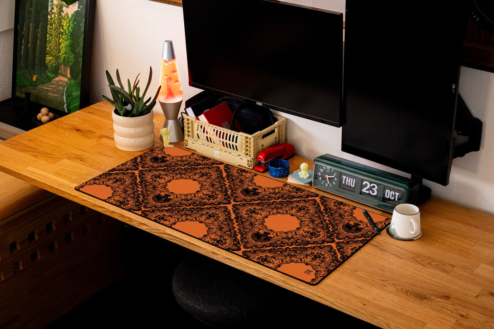 Gothic Diamonds desk mat in Black Lace on Orange, shown on a styled desk setup
