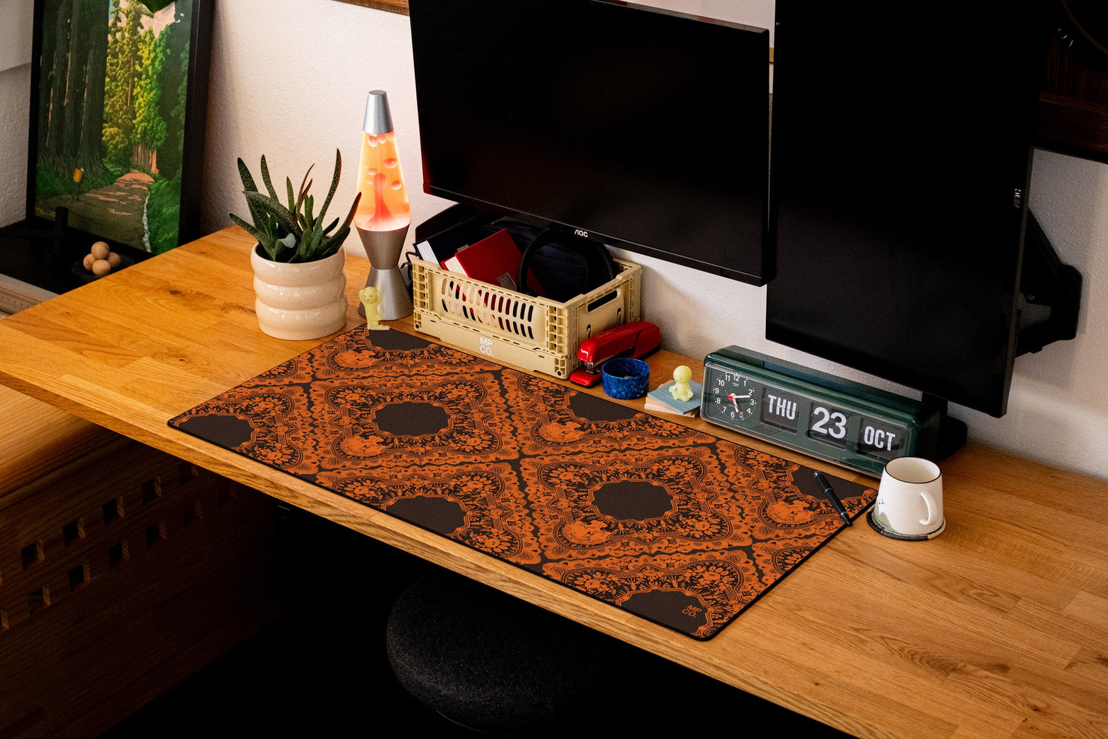 Gothic Diamonds desk mat in Orange Lace on Black, shown on a styled desk setup