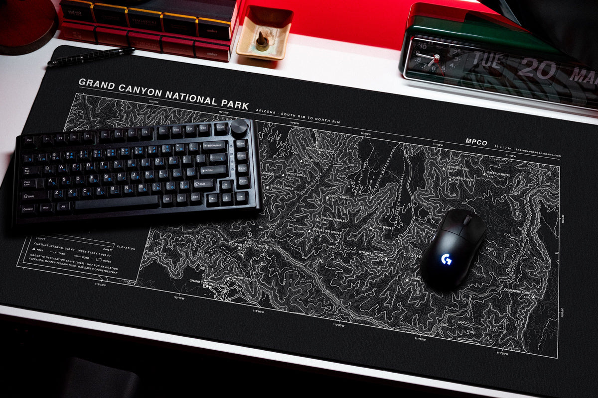 Grand Canyon National Park Topo Pad desk mat in Black / White, shown on a styled desk setup