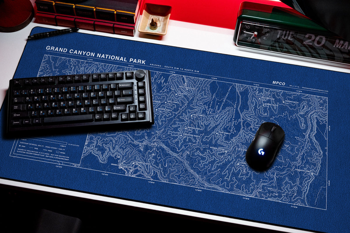 Grand Canyon National Park Topo Pad desk mat in Blue / White, shown on a styled desk setup