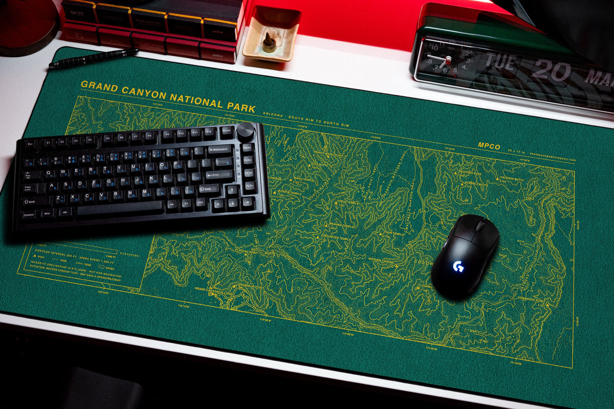 Grand Canyon National Park Topo Pad desk mat in Green / Yellow, shown on a styled desk setup