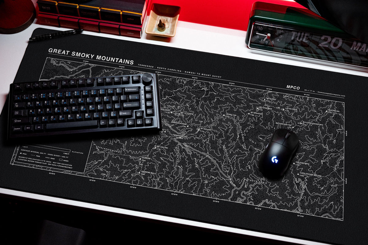 Great Smoky Mountains Topo Pad desk mat in Black / White, shown on a styled desk setup