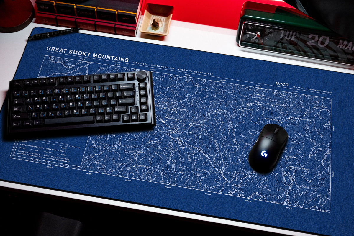 Great Smoky Mountains Topo Pad desk mat in Blue / White, shown on a styled desk setup