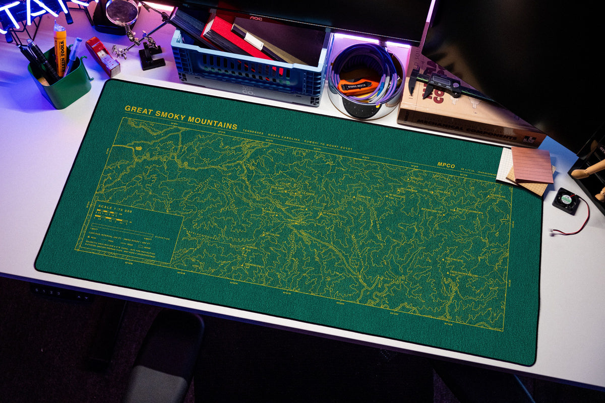 Great Smoky Mountains Topo Pad desk mat in Green / Yellow, shown on a styled desk setup