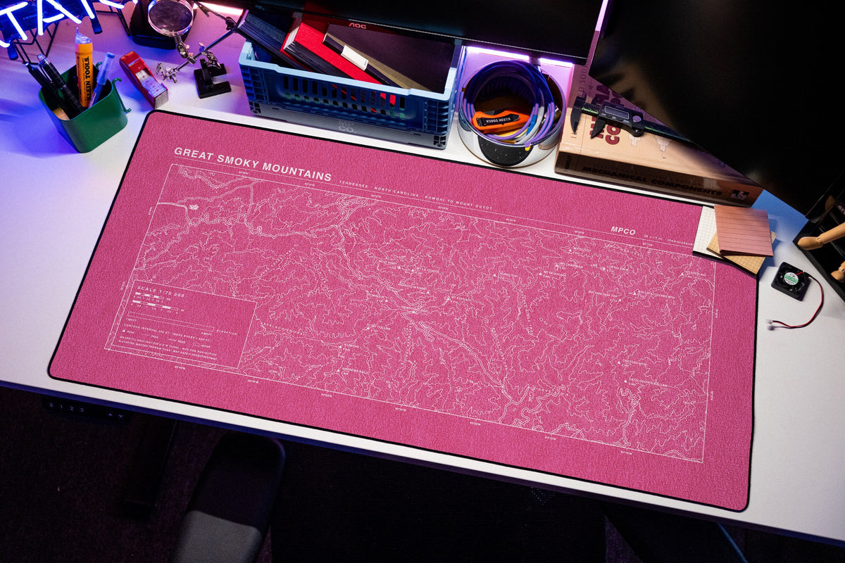Great Smoky Mountains Topo Pad desk mat in Pink / White, shown on a styled desk setup