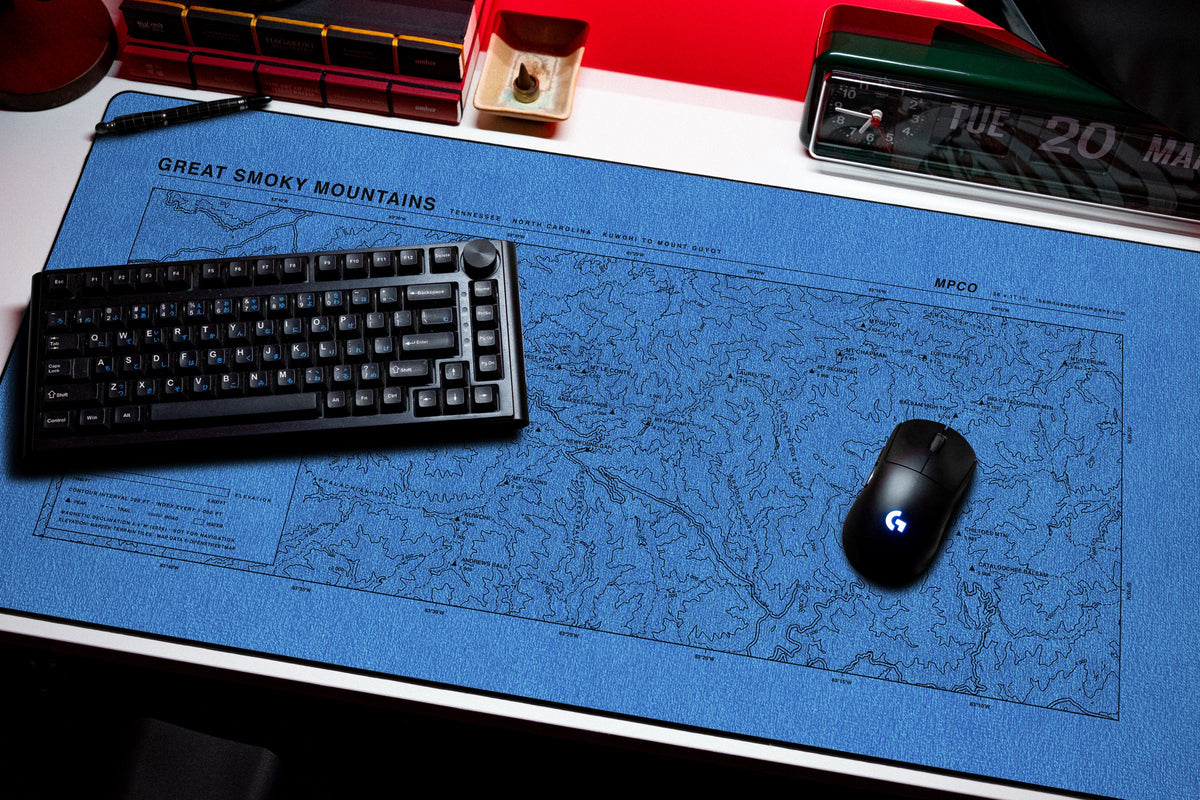 Great Smoky Mountains Topo Pad desk mat in Swiss Blue, shown on a styled desk setup