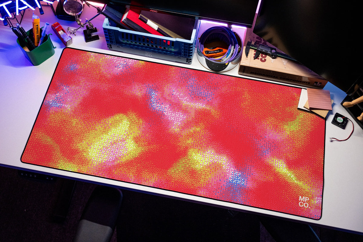 Hot Pixel desk mat in Cherry, shown on a styled desk setup
