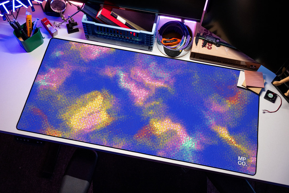 Hot Pixel desk mat in Cobalt, shown on a styled desk setup