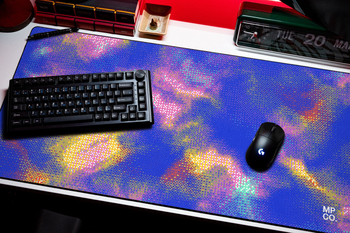 Hot Pixel desk mat in Cobalt, shown on a styled desk setup