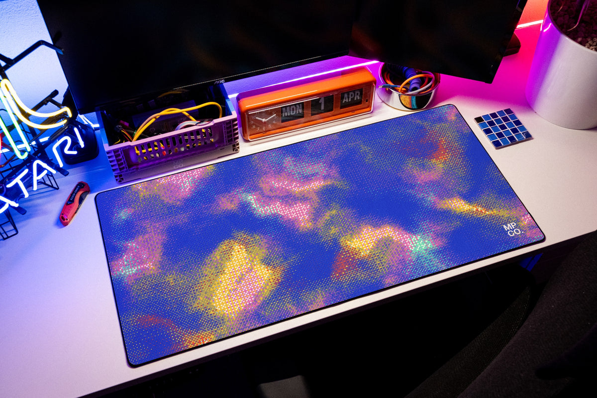 Hot Pixel desk mat in Cobalt, shown on a styled desk setup