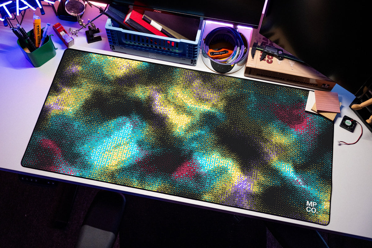 Hot Pixel desk mat in Midnight, shown on a styled desk setup