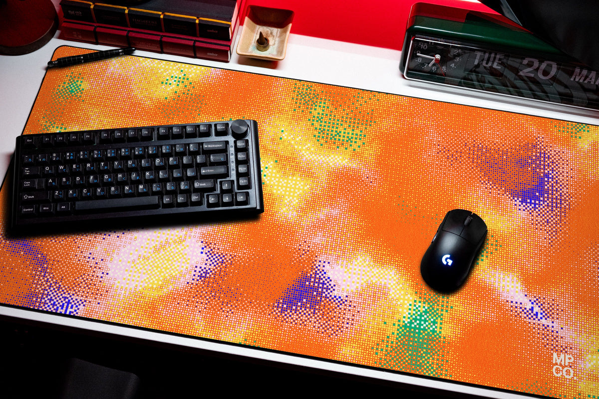Hot Pixel desk mat in Tangerine, shown on a styled desk setup