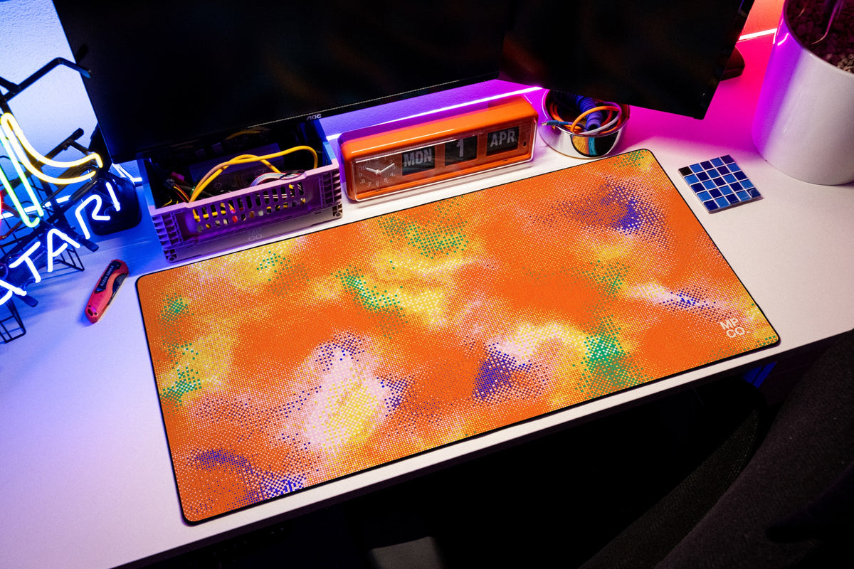 Hot Pixel desk mat in Tangerine, shown on a styled desk setup