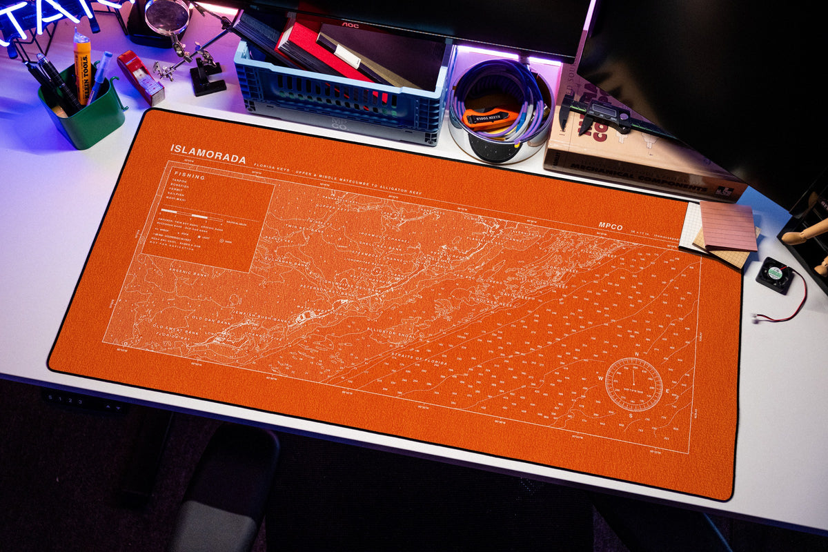 Islamorada Nautical Chart Pad desk mat in Orange / White, shown on a styled desk setup