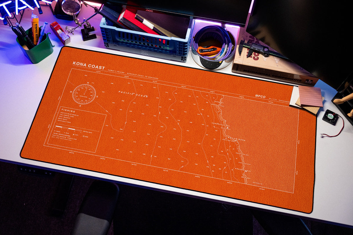 Kona Coast Nautical Chart Pad desk mat in Orange / White, shown on a styled desk setup