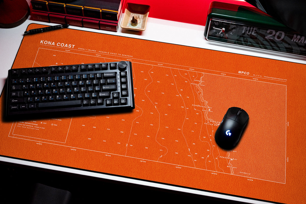 Kona Coast Nautical Chart Pad desk mat in Orange / White, shown on a styled desk setup