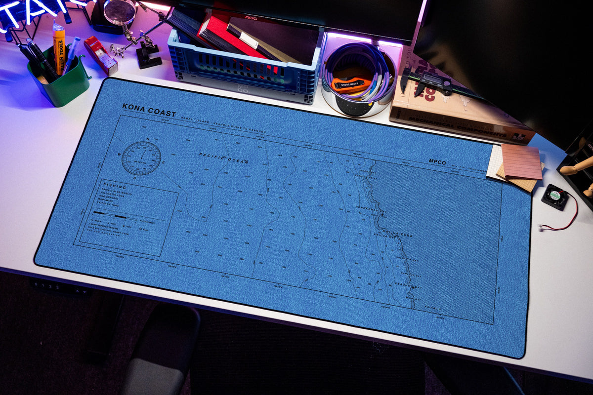 Kona Coast Nautical Chart Pad desk mat in Swiss Blue, shown on a styled desk setup