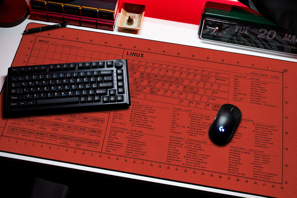 Linux Cheat Sheet Pad desk mat in Red / Black, shown on a styled desk setup