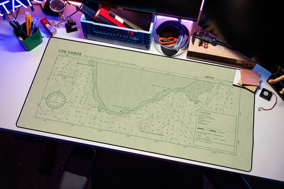 Los Cabos Nautical Chart Pad desk mat in Buff / Green, shown on a styled desk setup