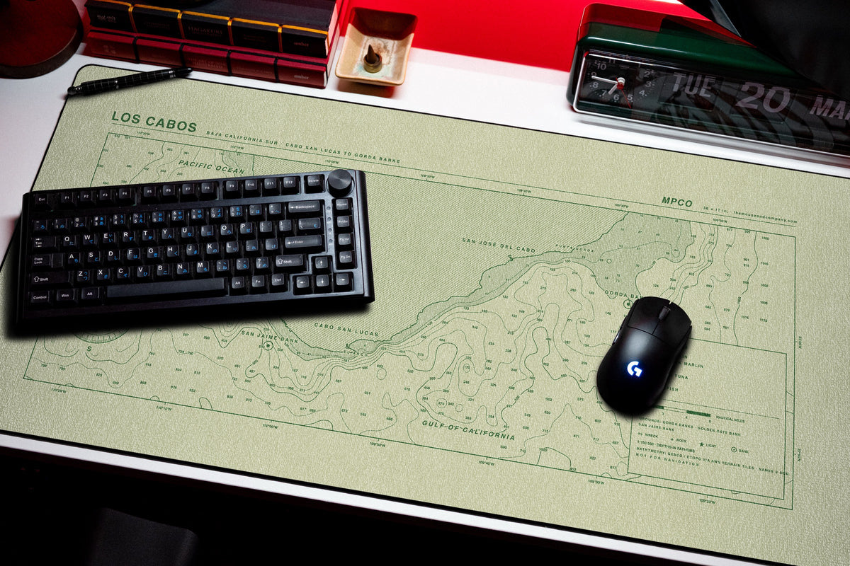 Los Cabos Nautical Chart Pad desk mat in Buff / Green, shown on a styled desk setup
