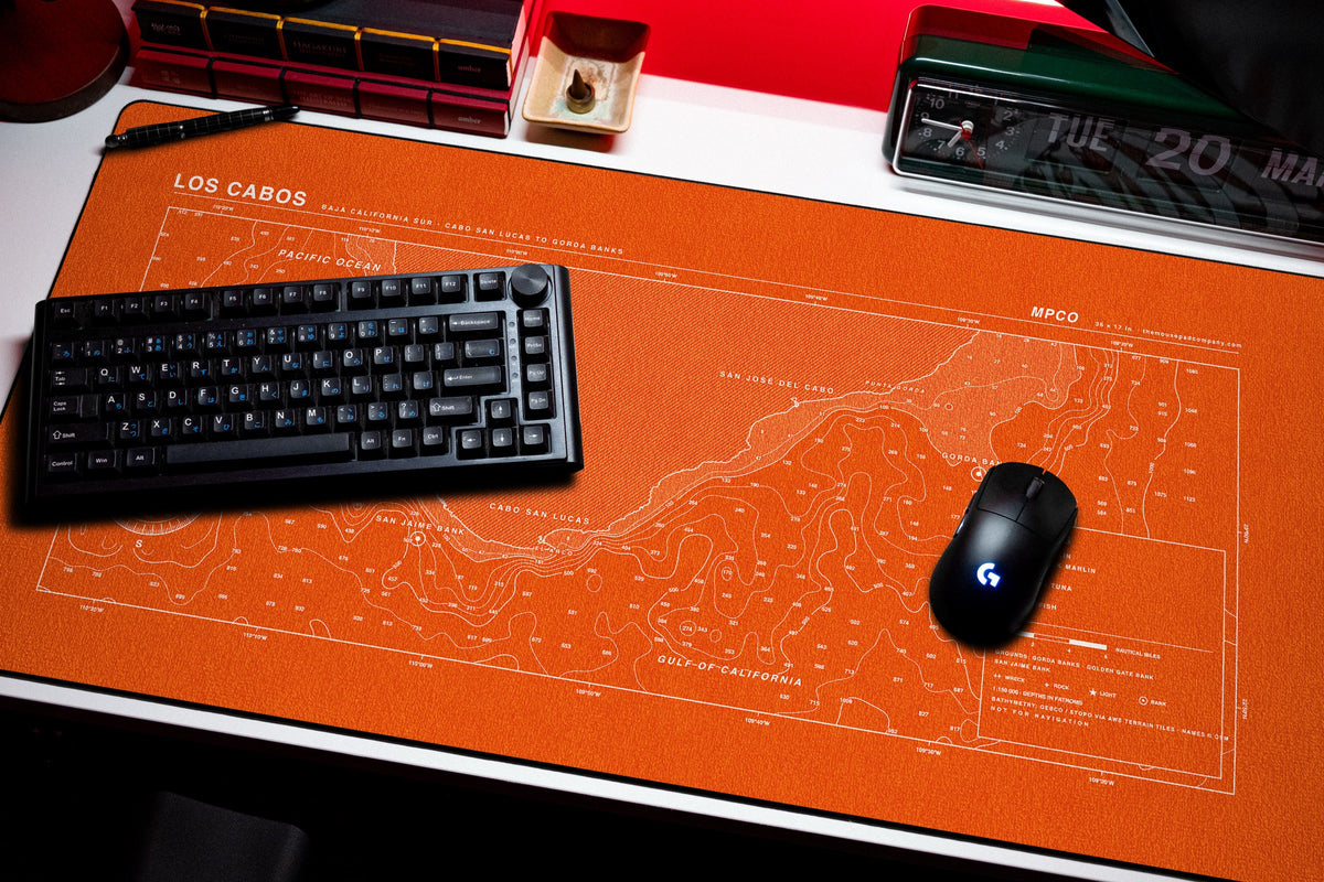 Los Cabos Nautical Chart Pad desk mat in Orange / White, shown on a styled desk setup