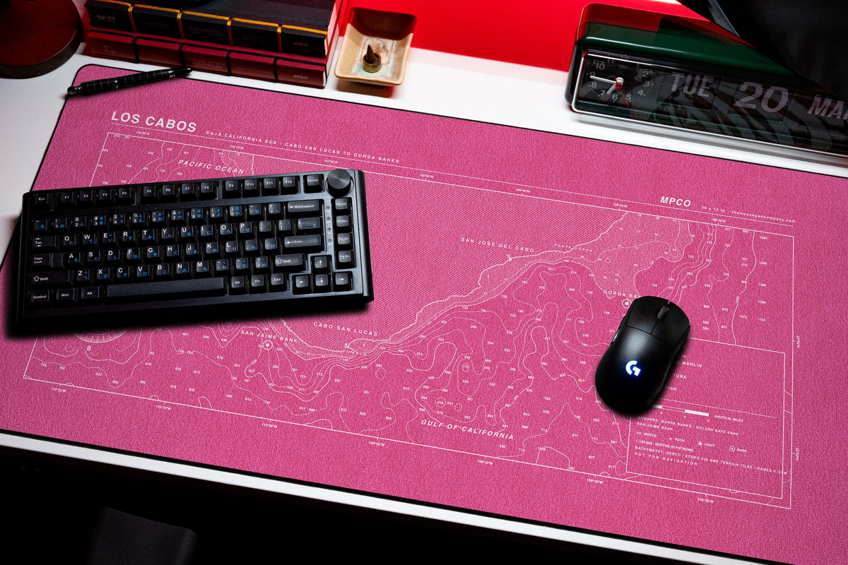 Los Cabos Nautical Chart Pad desk mat in Pink / White, shown on a styled desk setup