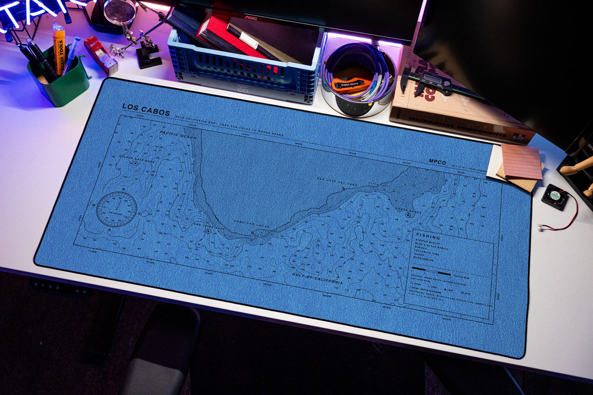 Los Cabos Nautical Chart Pad desk mat in Swiss Blue, shown on a styled desk setup