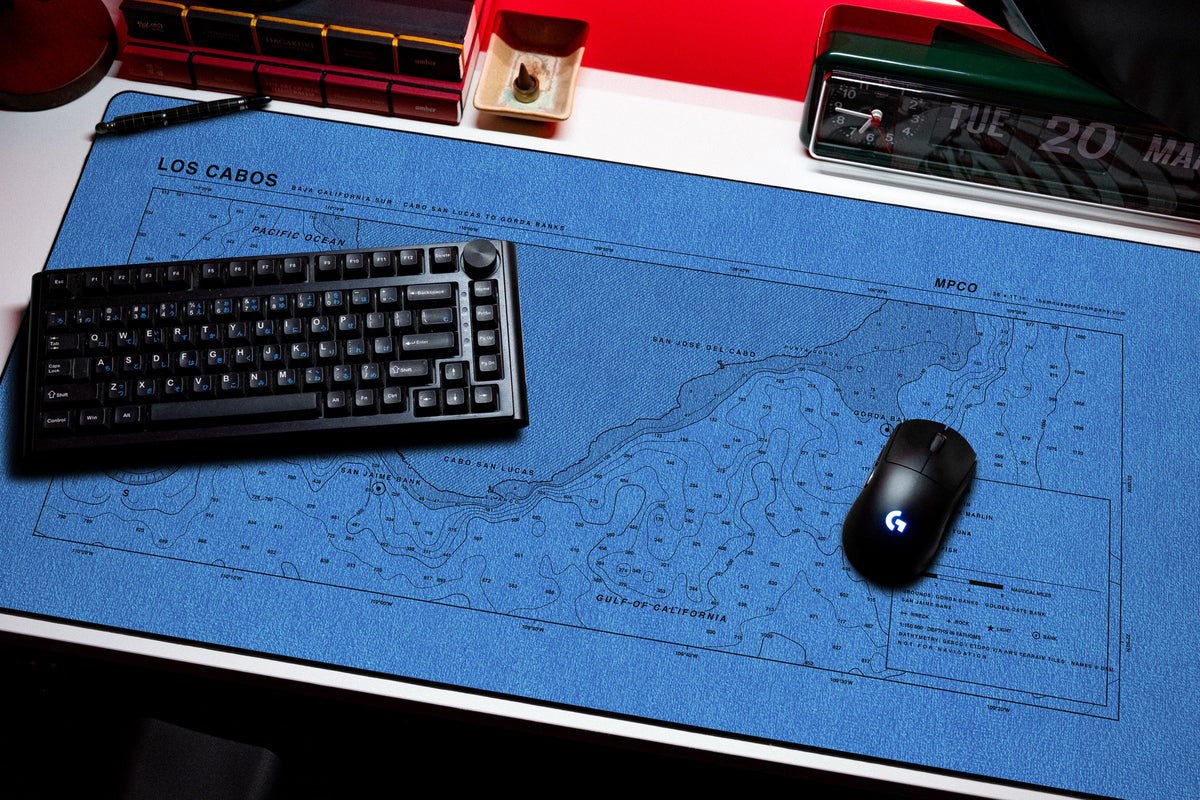 Los Cabos Nautical Chart Pad desk mat in Swiss Blue, shown on a styled desk setup