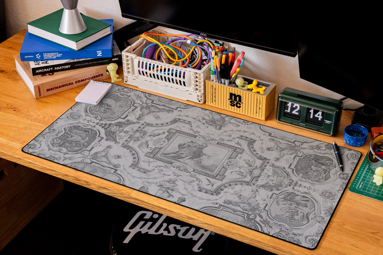 Martelli Hall desk mat in Dark, shown on a styled desk setup