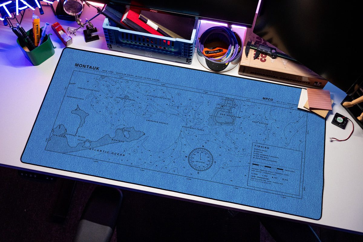 Montauk Nautical Chart Pad desk mat in Swiss Blue, shown on a styled desk setup