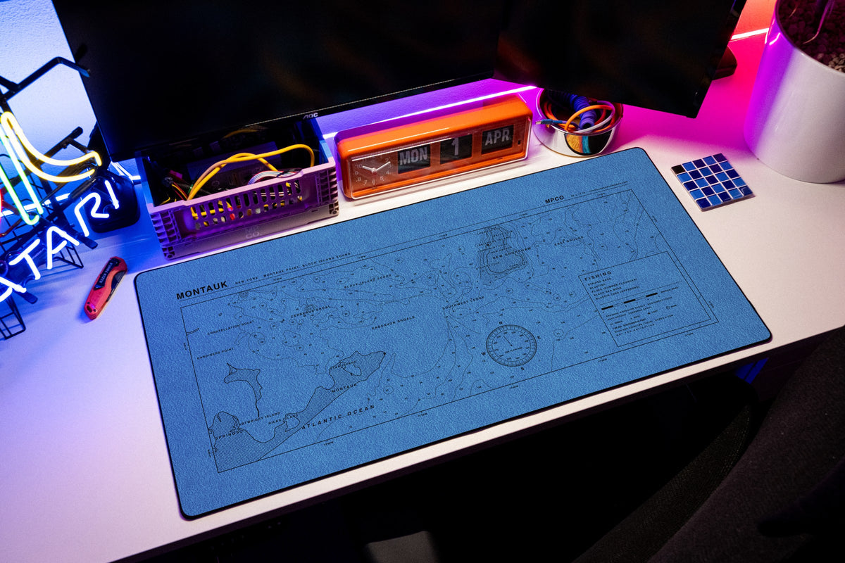 Montauk Nautical Chart Pad desk mat in Swiss Blue, shown on a styled desk setup