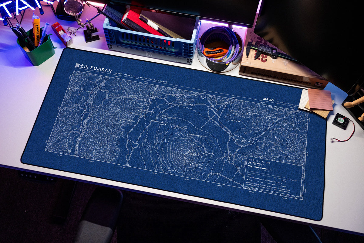 Mount Fuji Topo Pad desk mat in Blue / White, shown on a styled desk setup