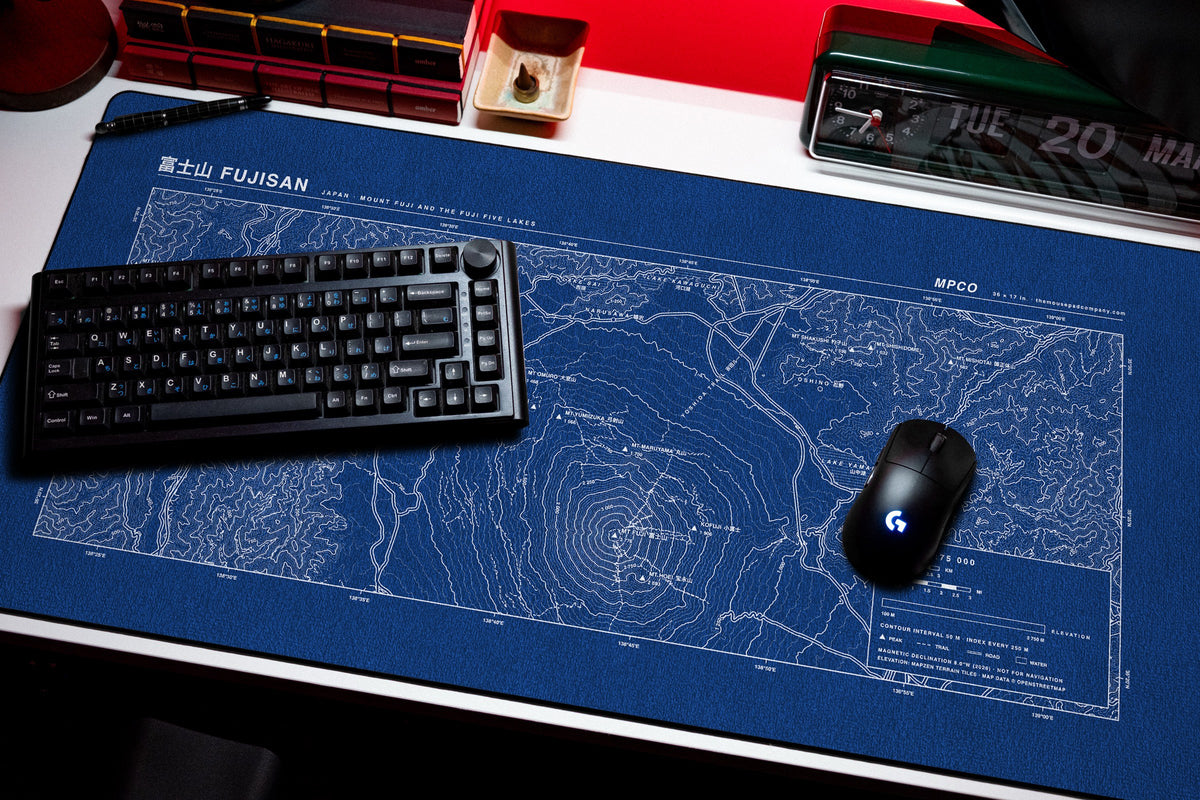 Mount Fuji Topo Pad desk mat in Blue / White, shown on a styled desk setup