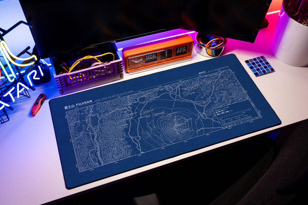 Mount Fuji Topo Pad desk mat in Blue / White, shown on a styled desk setup