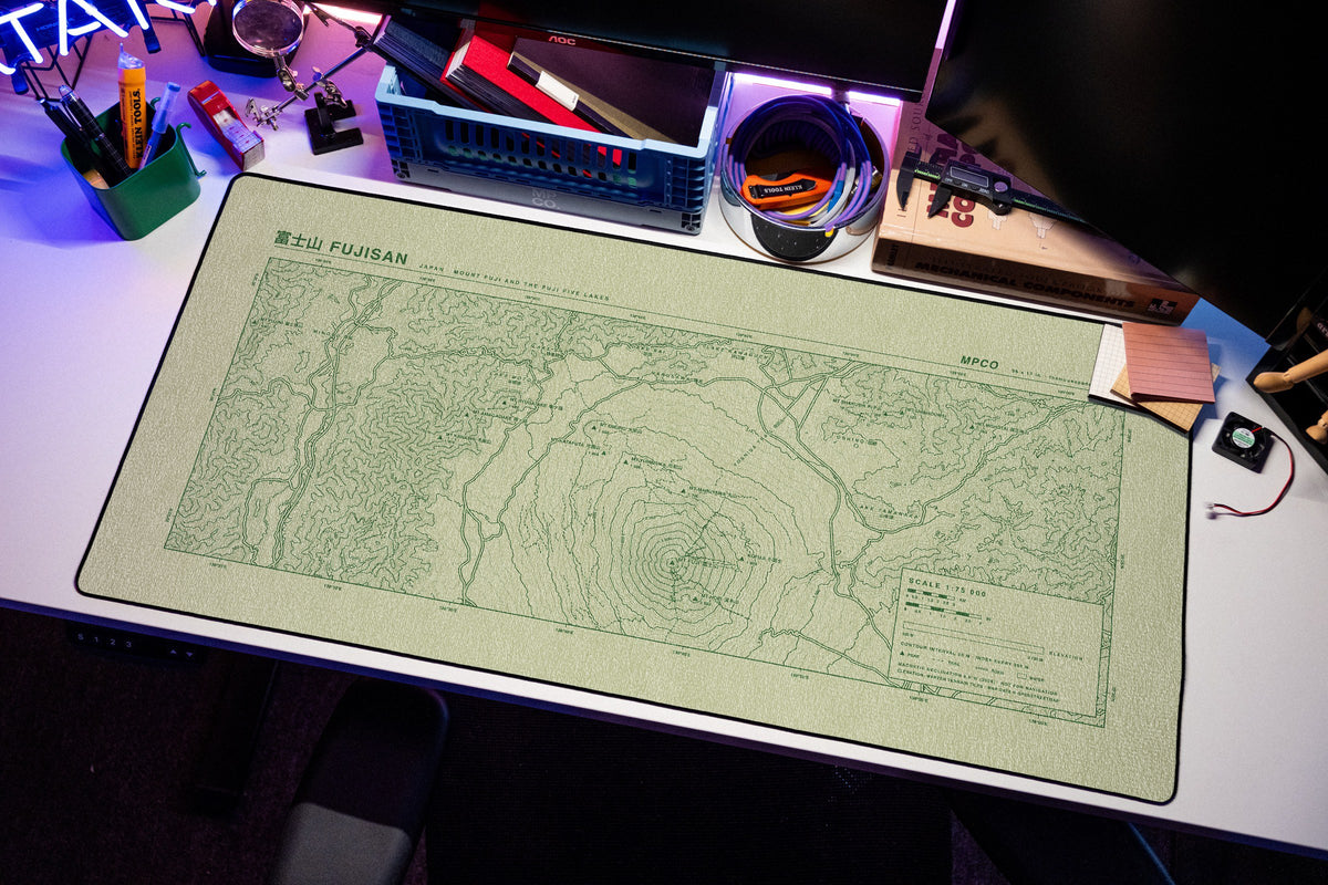 Mount Fuji Topo Pad desk mat in Buff / Green, shown on a styled desk setup