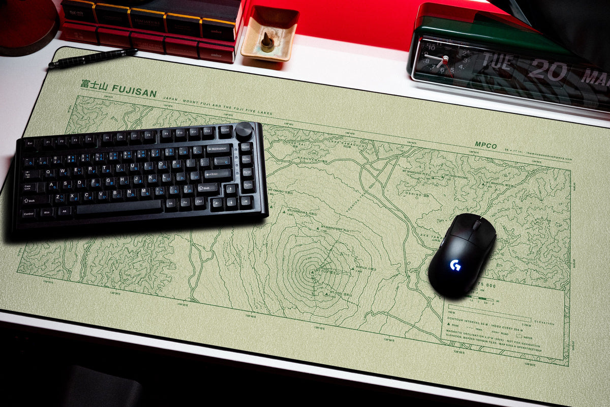 Mount Fuji Topo Pad desk mat in Buff / Green, shown on a styled desk setup