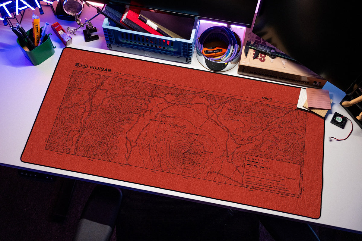 Mount Fuji Topo Pad desk mat in Red / Black, shown on a styled desk setup