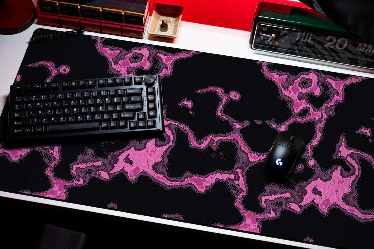 Neon desk mat in Magenta, shown on a styled desk setup