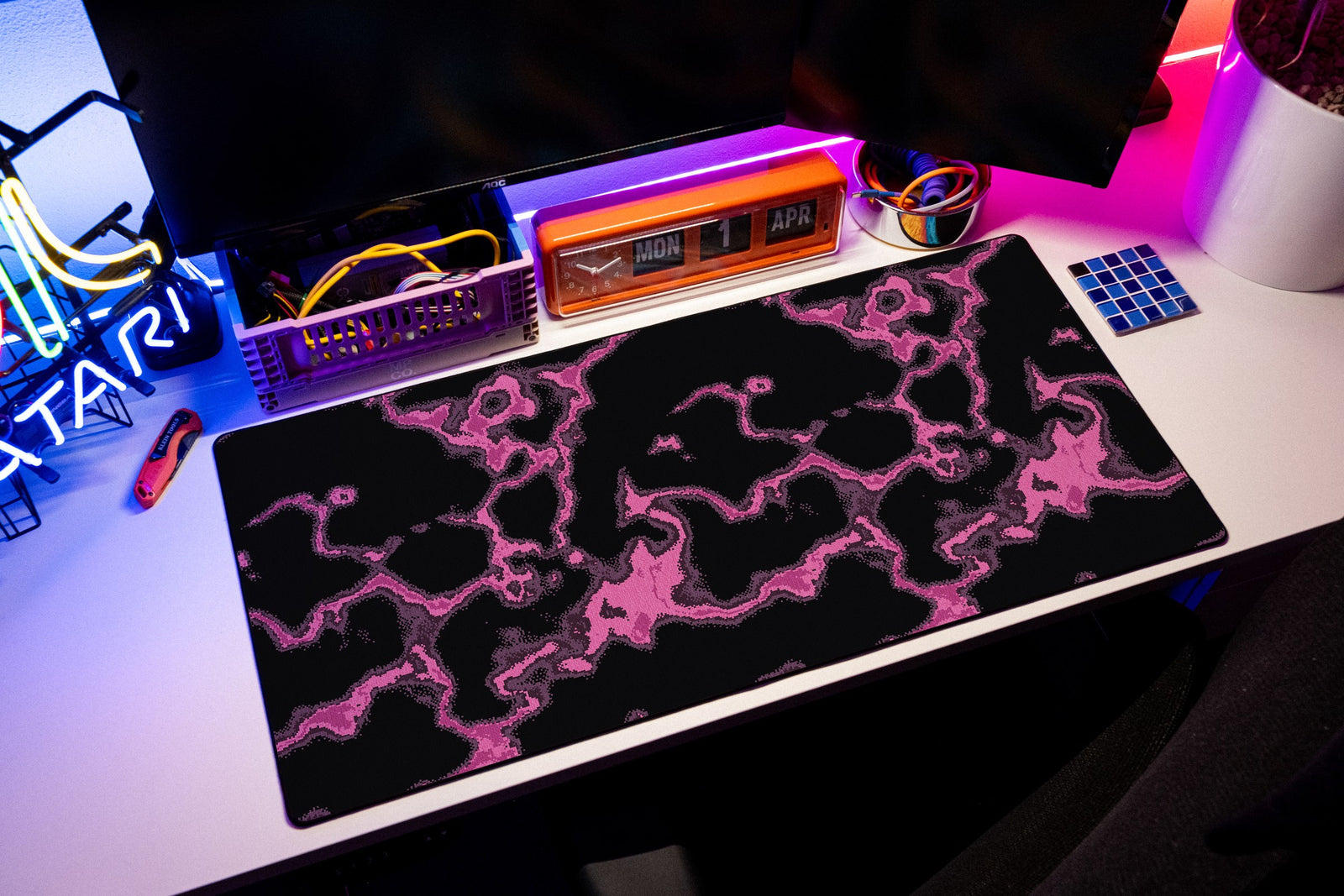 Neon desk mat in Magenta, shown on a styled desk setup