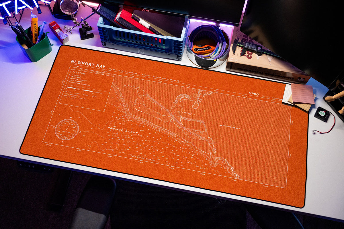Newport Bay Nautical Chart Pad desk mat in Orange / White, shown on a styled desk setup