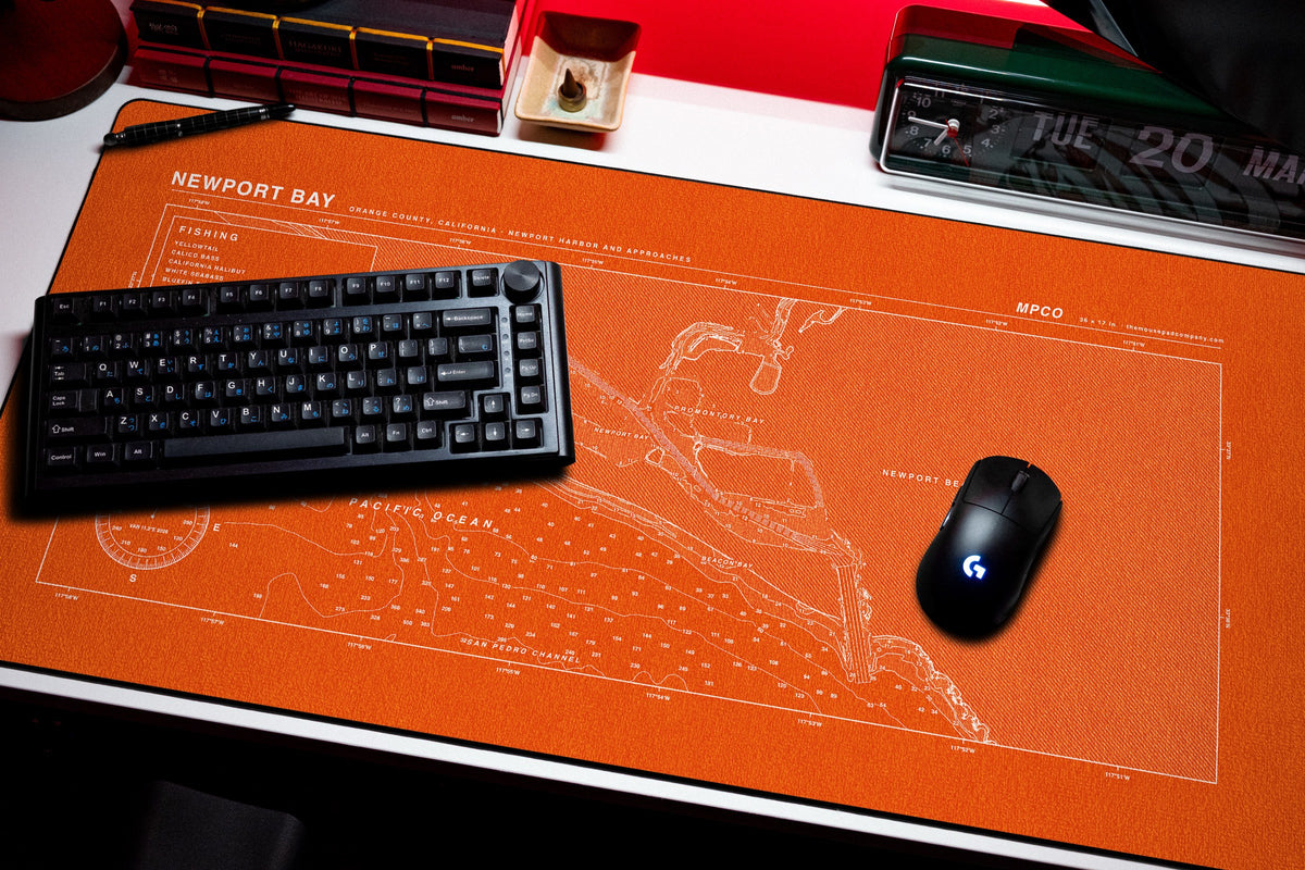 Newport Bay Nautical Chart Pad desk mat in Orange / White, shown on a styled desk setup