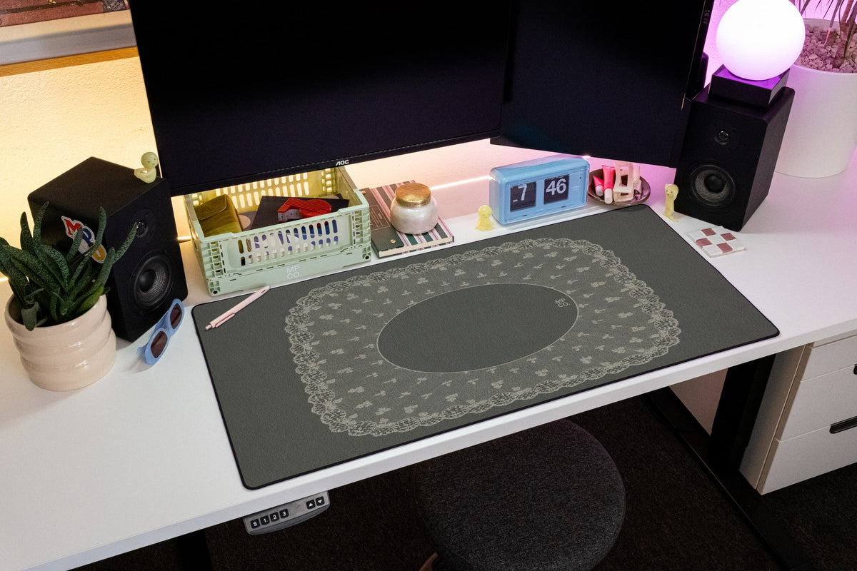 Oval Veil desk mat in Charcoal, shown on a styled desk setup