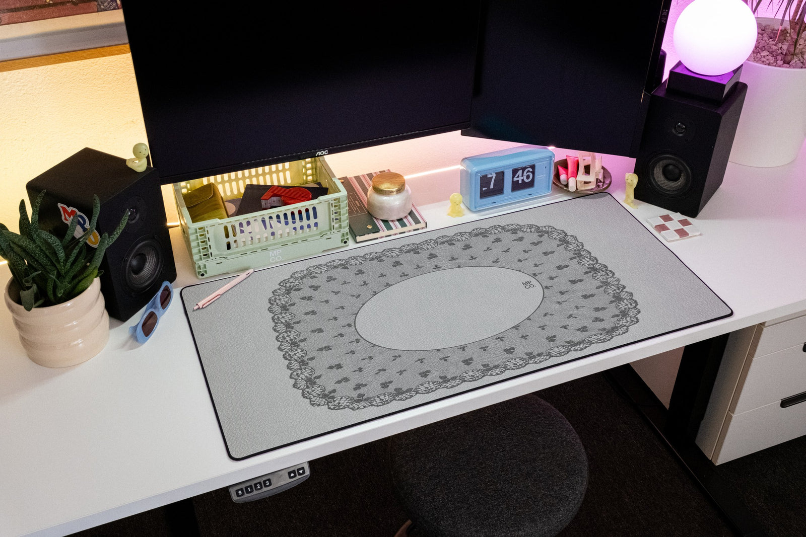 Oval Veil desk mat in Porcelain, shown on a styled desk setup